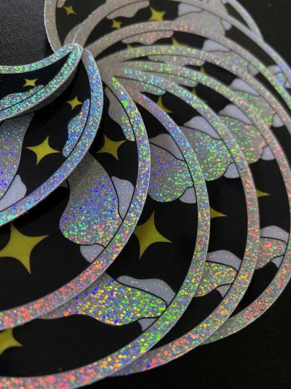 Glittery iridescent moon sticker closeup of glitter